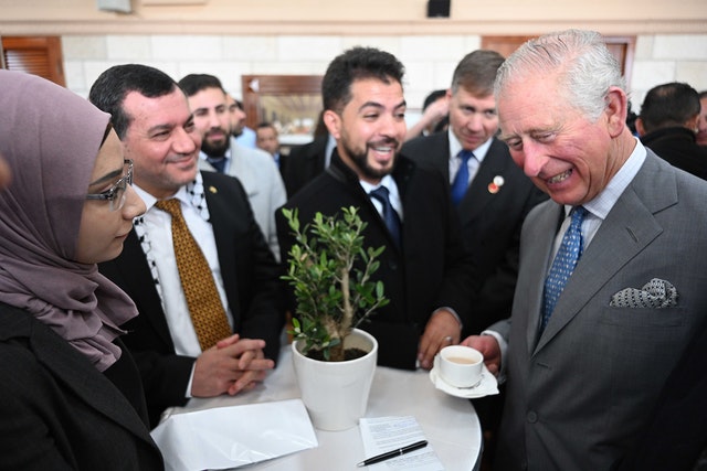 The Prince of Wales speaks with Rua Ahmed Abuoda (left) from the Nor’s Women Empowerment Group and other Palestinian refugees at the Casa Nova Franciscan pilgrim house in Bethlehem (Neil Hall/PA)